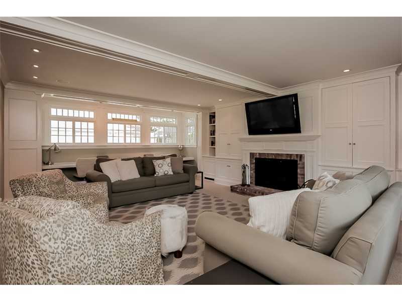 20 Beach Drive Darien, CT 06820 - Photo 11 of 25 a living room with furniture a flat screen tv and a fireplace