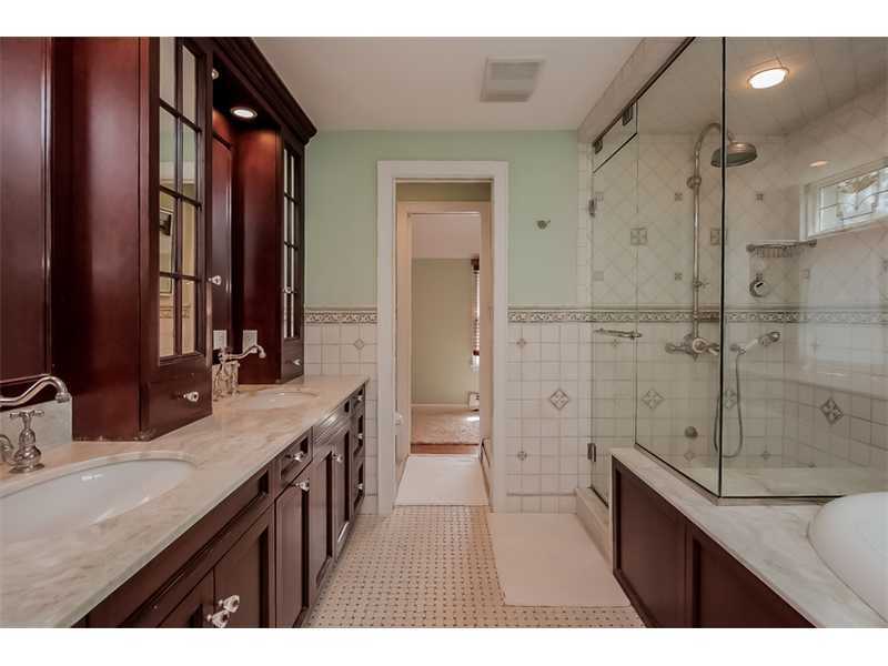 20 Beach Drive Darien, CT 06820 - Photo 16 of 25 a bathroom with a granite countertop sink a toilet a mirror and shower