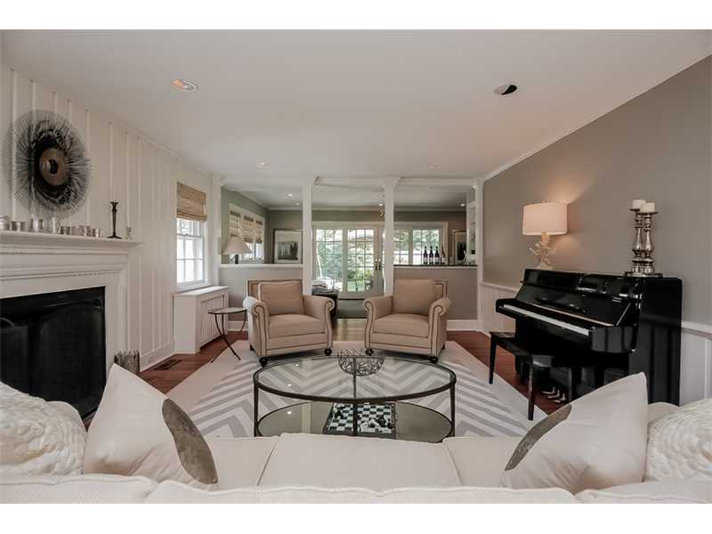 20 Beach Drive Darien, CT 06820 - Photo 4 of 25 a living room with furniture a fireplace and a flat screen tv