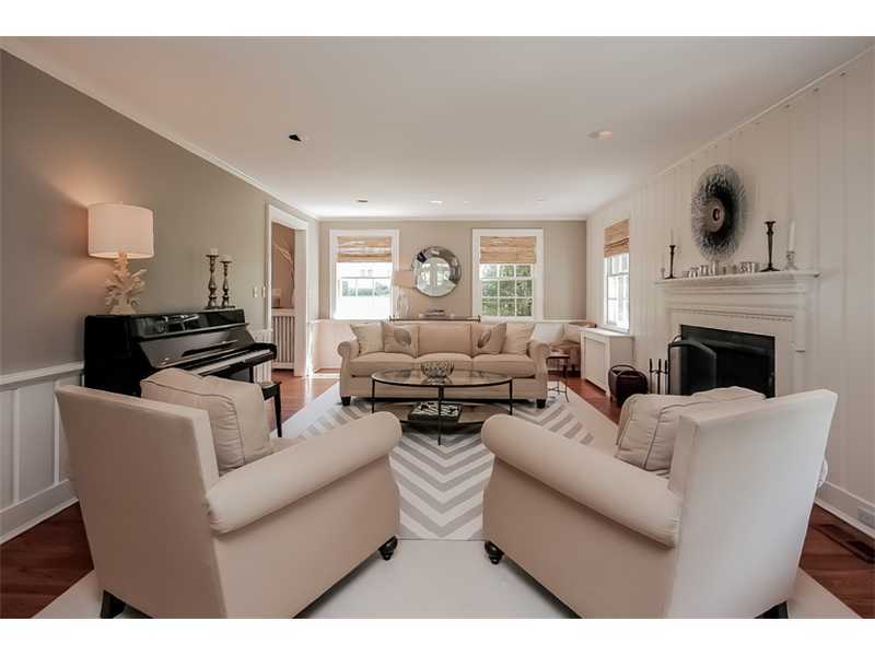 20 Beach Drive Darien, CT 06820 - Photo 5 of 25 a living room with furniture a fireplace and a large window