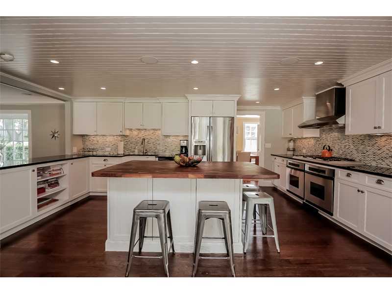 20 Beach Drive Darien, CT 06820 - Photo 8 of 25 a kitchen with stainless steel appliances kitchen island granite countertop a stove a sink a microwave and a refrigerator