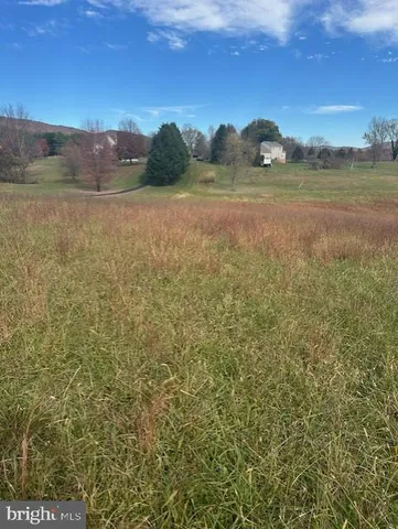 a view of mountain with sunset in background