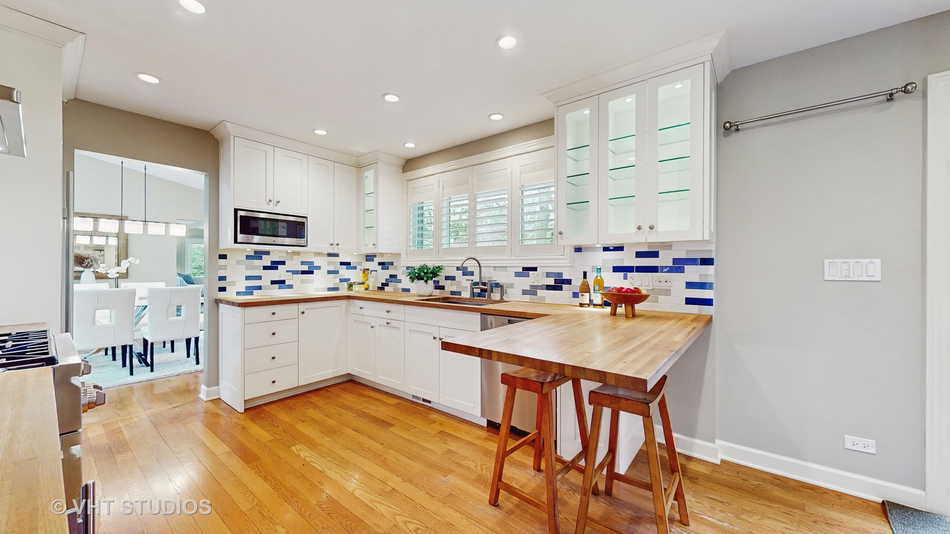 1321 Sheridan Road Wilmette, IL 60091 - Photo 15 of 36 a kitchen with white cabinets and stainless steel appliances