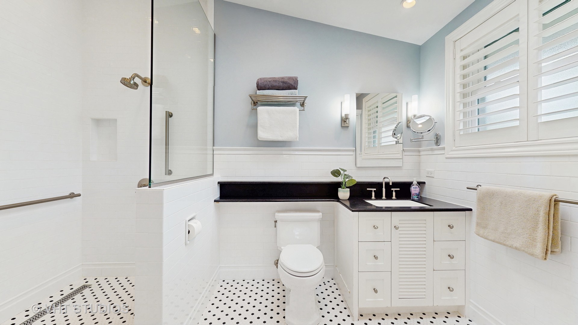 1321 Sheridan Road Wilmette, IL 60091 - Photo 20 of 36 a bathroom with a sink a toilet and mirror