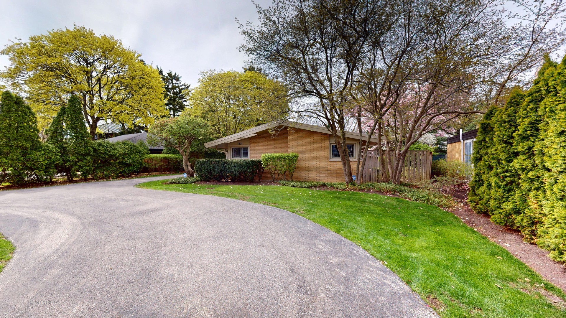 1321 Sheridan Road Wilmette, IL 60091 - Photo 3 of 36 a yellow house with trees in front of it