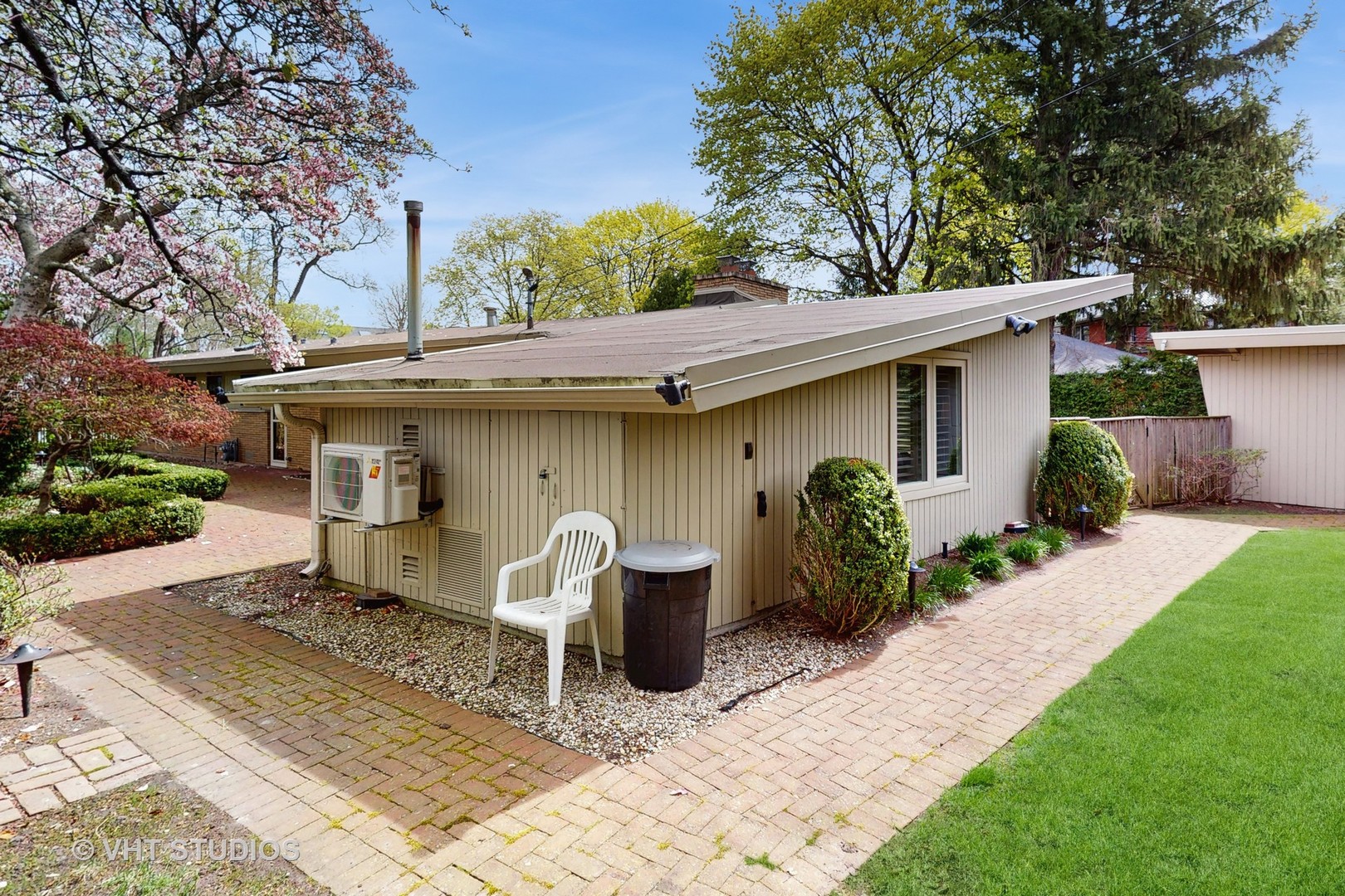1321 Sheridan Road Wilmette, IL 60091 - Photo 33 of 36 a view of a patio with table and chairs potted plants and large tree