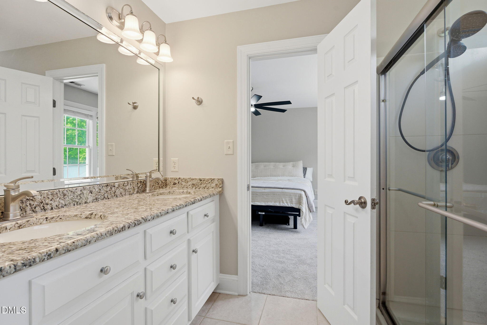 5416 Pulley Town Road Zebulon, NC 27597 - Photo 28 of 74 a en suite bathroom with a granite countertop double vanity sink a mirror and a shower