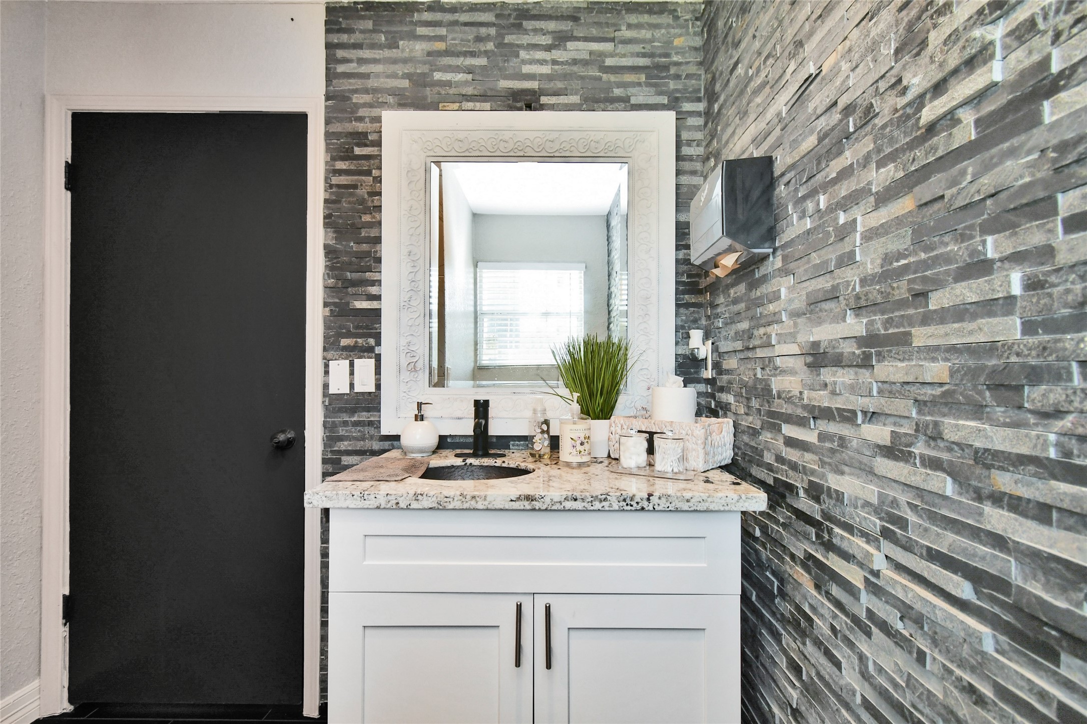5035 North Freeway Houston, TX 77022 - Photo 18 of 38 a bathroom with a granite countertop sink a mirror and a shower