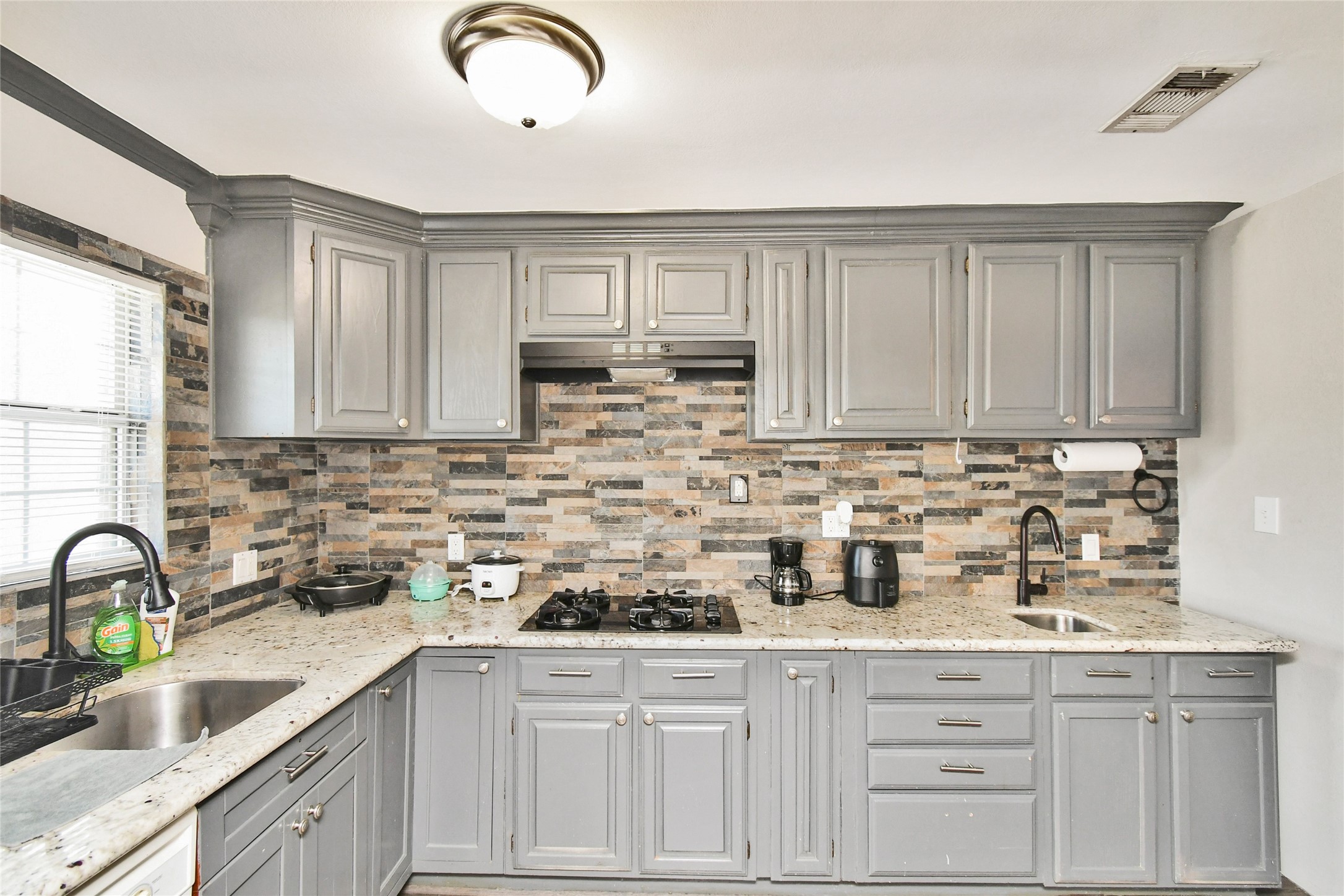5035 North Freeway Houston, TX 77022 - Photo 7 of 38 a kitchen with stainless steel appliances granite countertop a sink a stove and cabinets