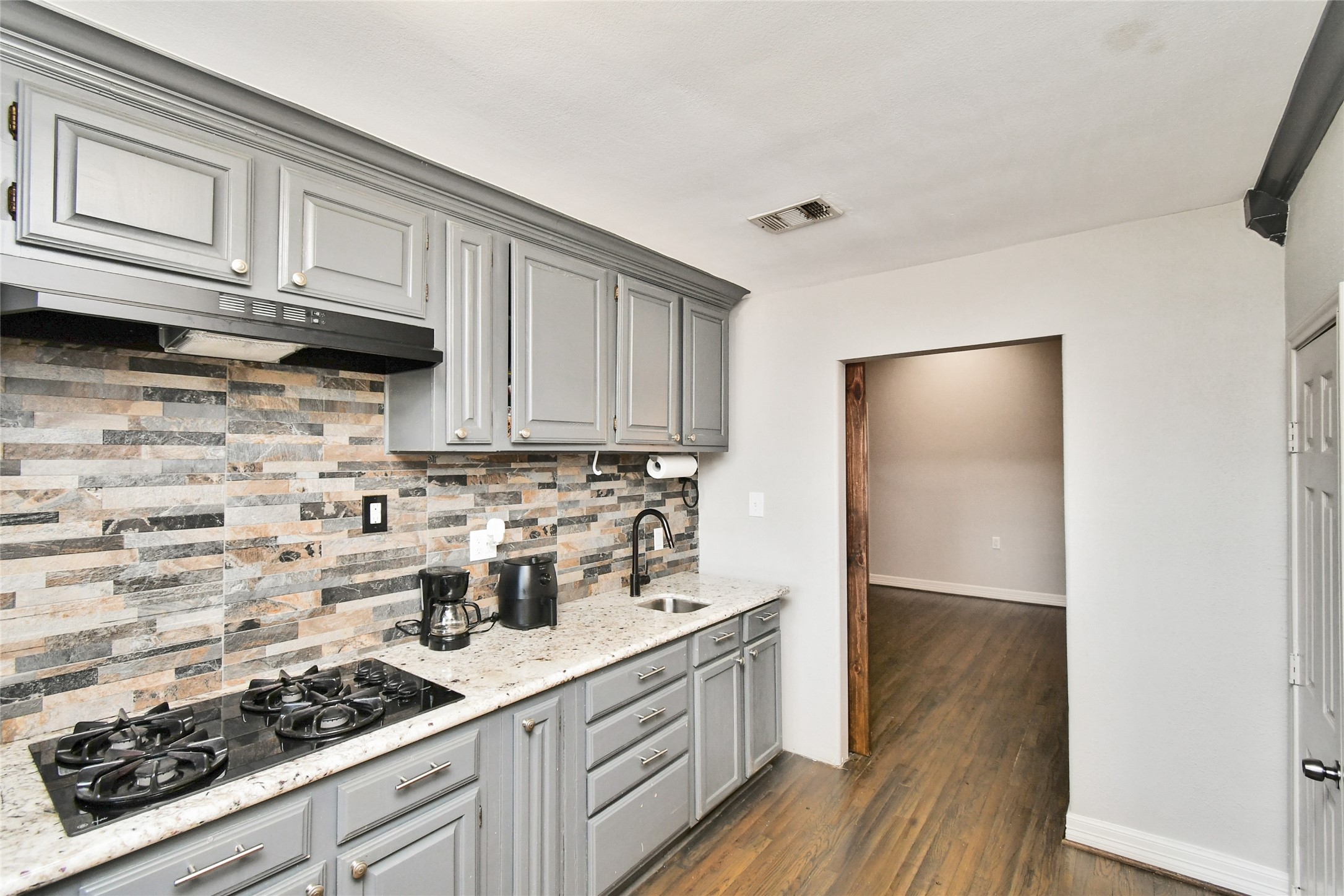 5035 North Freeway Houston, TX 77022 - Photo 8 of 38 a kitchen with stainless steel appliances granite countertop a stove a sink and cabinets