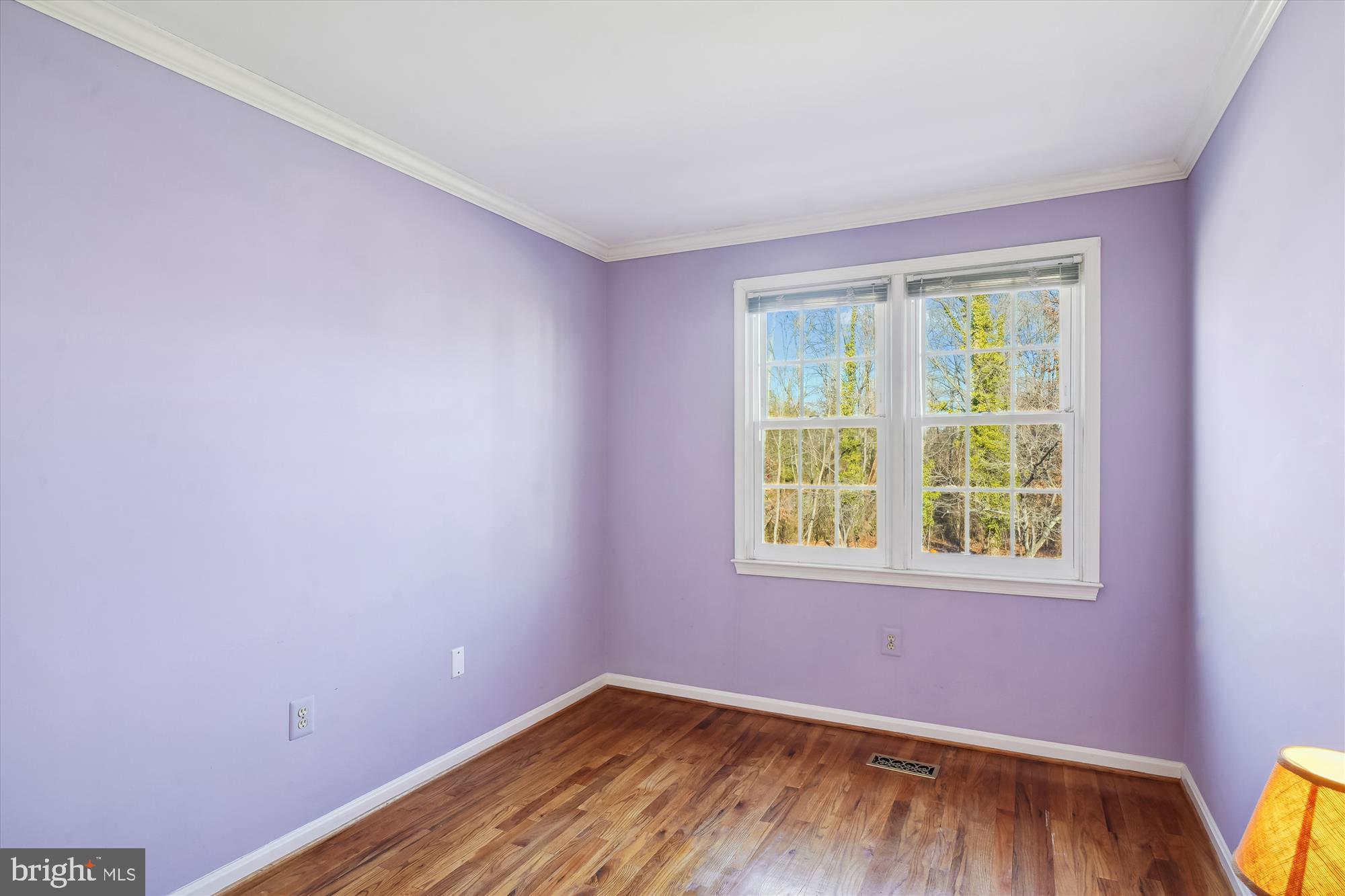 1046 Windrush Lane, Unit 38 Sandy Spring, MD 20860 - Photo 27 of 63 a view of an empty room with wooden floor and a window