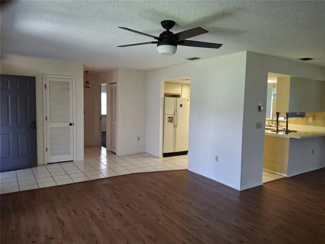 a view of a kitchen with wooden floor and a sink