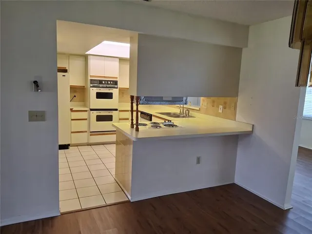 a kitchen with white cabinets and white appliances