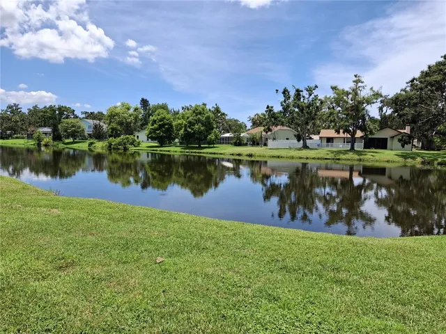 a view of a lake with a house in the background