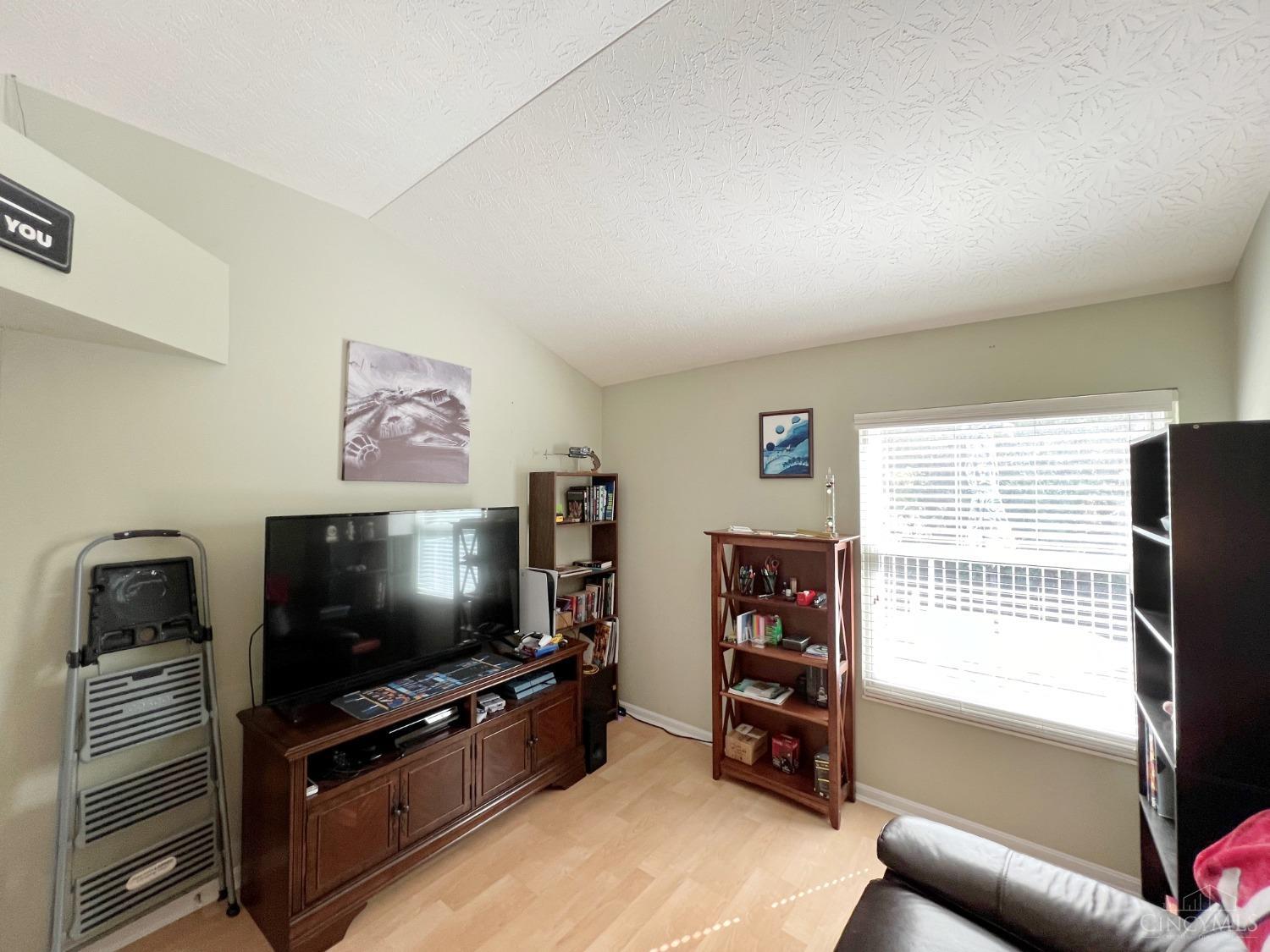 8408 Ridge Pointe Court, Unit 13 Reading, OH 45237 - Photo 23 of 39 Here's the 3rd bedroom with laminate flooring and a cathedral ceiling.