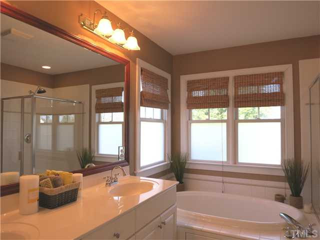 10805 Sagehurst Place Raleigh, NC 27614 - Photo 16 of 25 The lg Master Bath offers a long vanity w/dbl sinks, deep soaking tub, tile flr, lg tiled shower, lots of windows, linen closet & private toilet rm. Master Bath/Spa