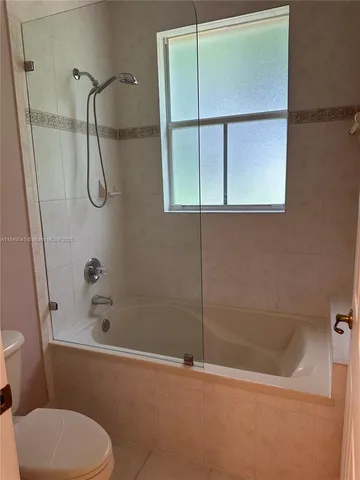 a bathroom with a tub and a shower