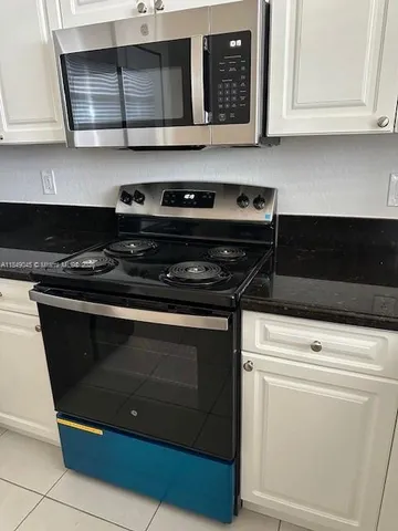 a stove top oven sitting inside of a kitchen