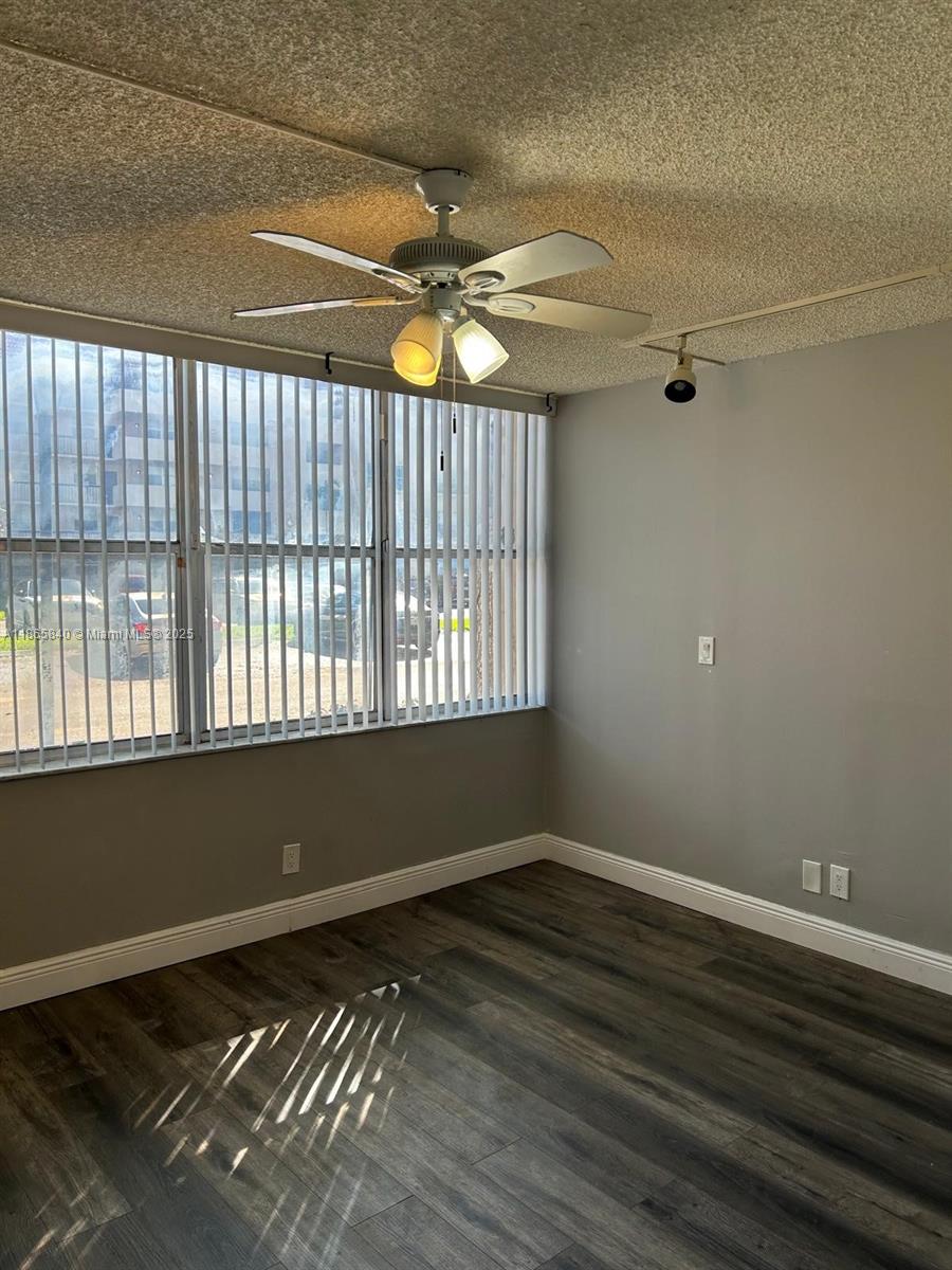 3671 Environ Boulevard, Unit 164 Lauderhill, FL 33319 - Photo 12 of 27 a view of an empty room with wooden floor and a window