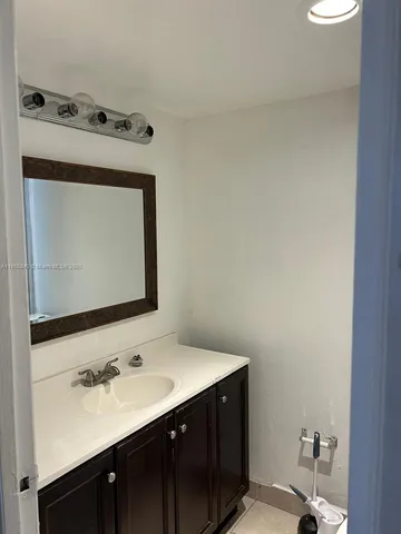 a bathroom with a sink vanity and a mirror