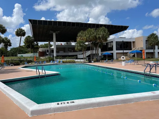 a house view with swimming pool and sitting space