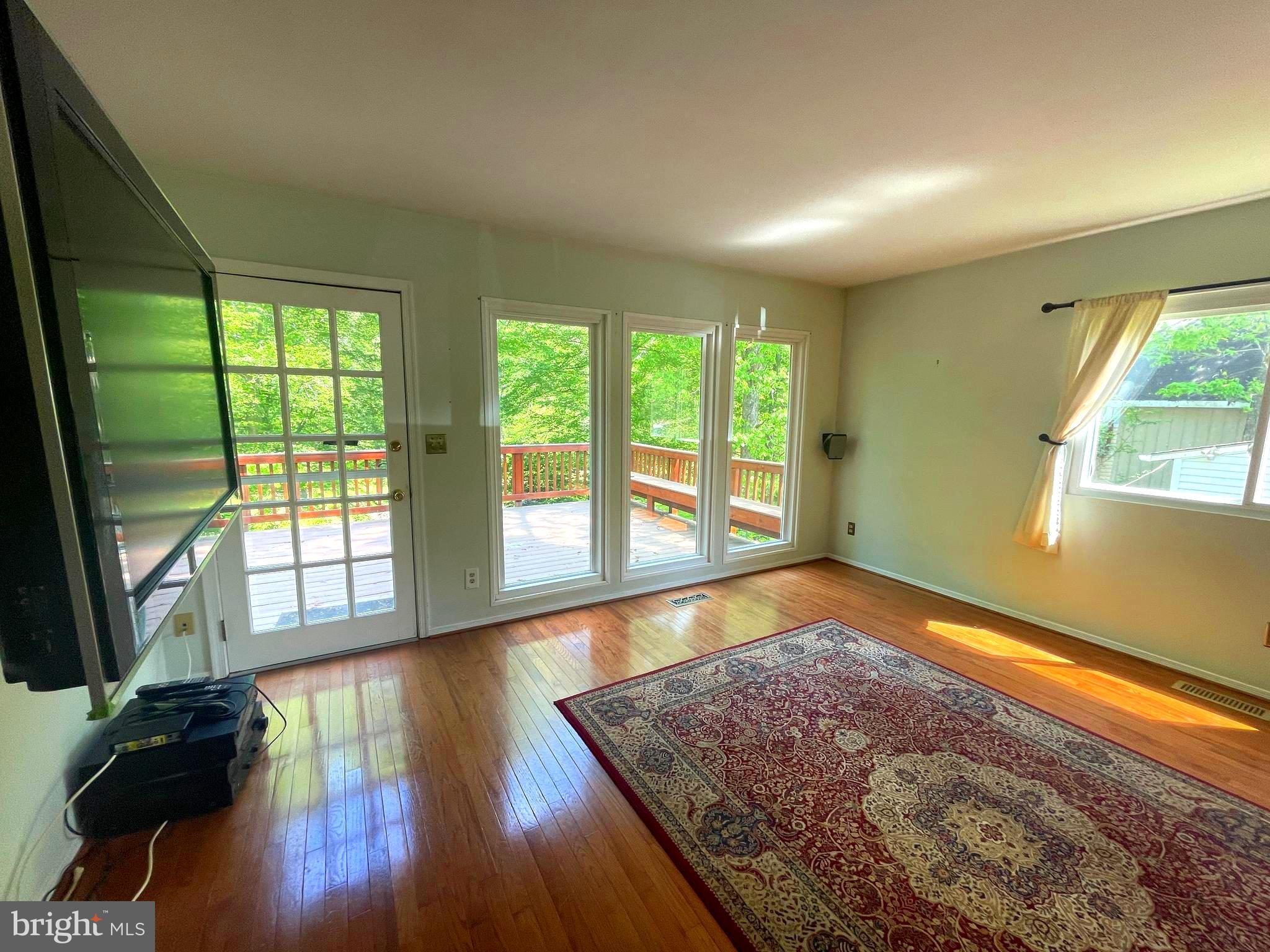 7809 Lake Drive Manassas, VA 20111 - Photo 12 of 44 a view of an empty room with wooden floor and a window