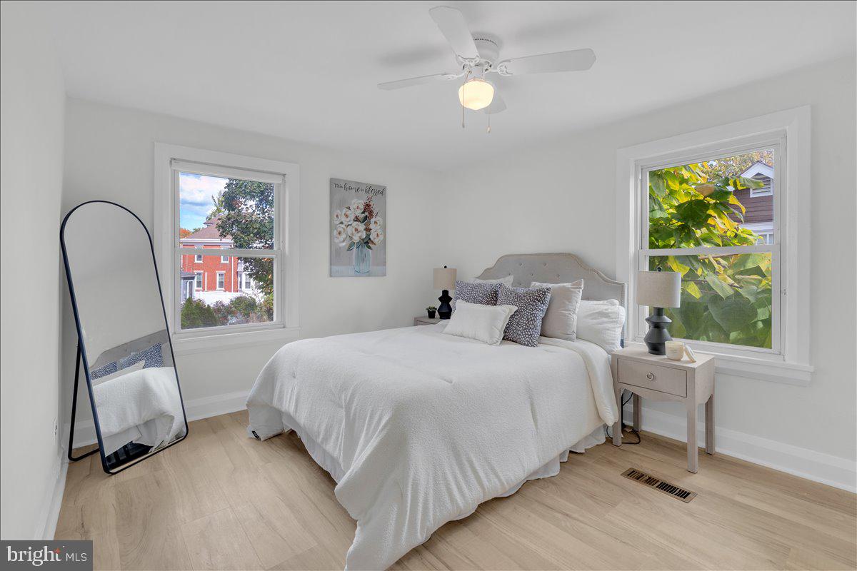111 Ellis Street Haddonfield, NJ 08033 - Photo 11 of 20 a bedroom with a bed a window and painting on the wall