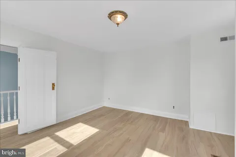 a view of a room with wooden floor and window