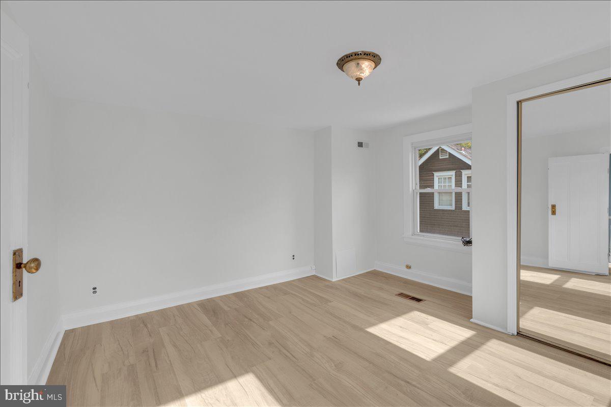 111 Ellis Street Haddonfield, NJ 08033 - Photo 14 of 20 an empty room with wooden floor and windows