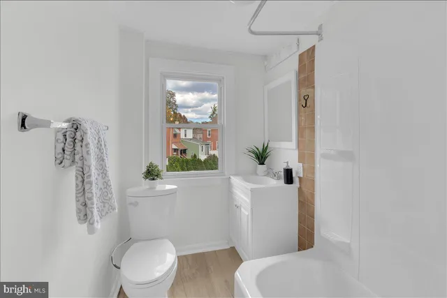 a white toilet sitting next to a bathroom sink