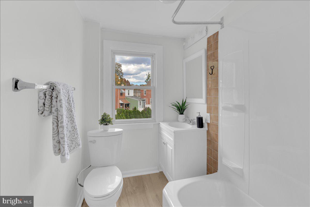 111 Ellis Street Haddonfield, NJ 08033 - Photo 16 of 20 a white toilet sitting next to a bathroom sink