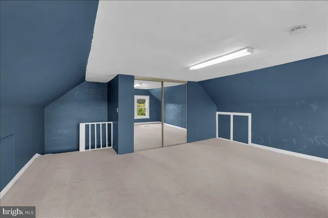 a bedroom with a large bed and closet with window