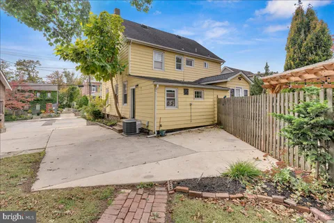a view of a white house with a large windows and plants