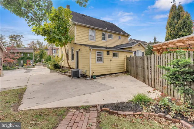 a view of a white house with a large windows and plants