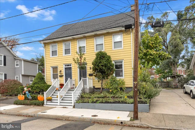 a front view of a house with tree s