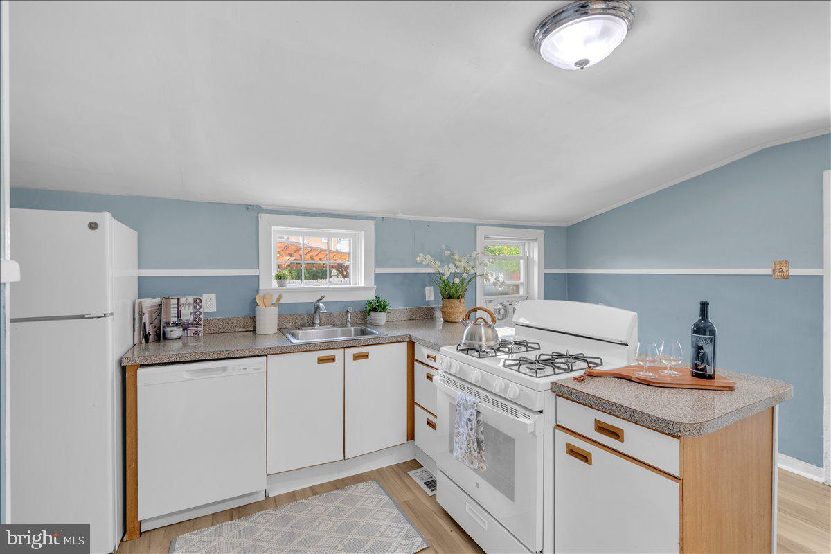 111 Ellis Street Haddonfield, NJ 08033 - Photo 9 of 20 a kitchen with a sink a stove a refrigerator and white cabinets