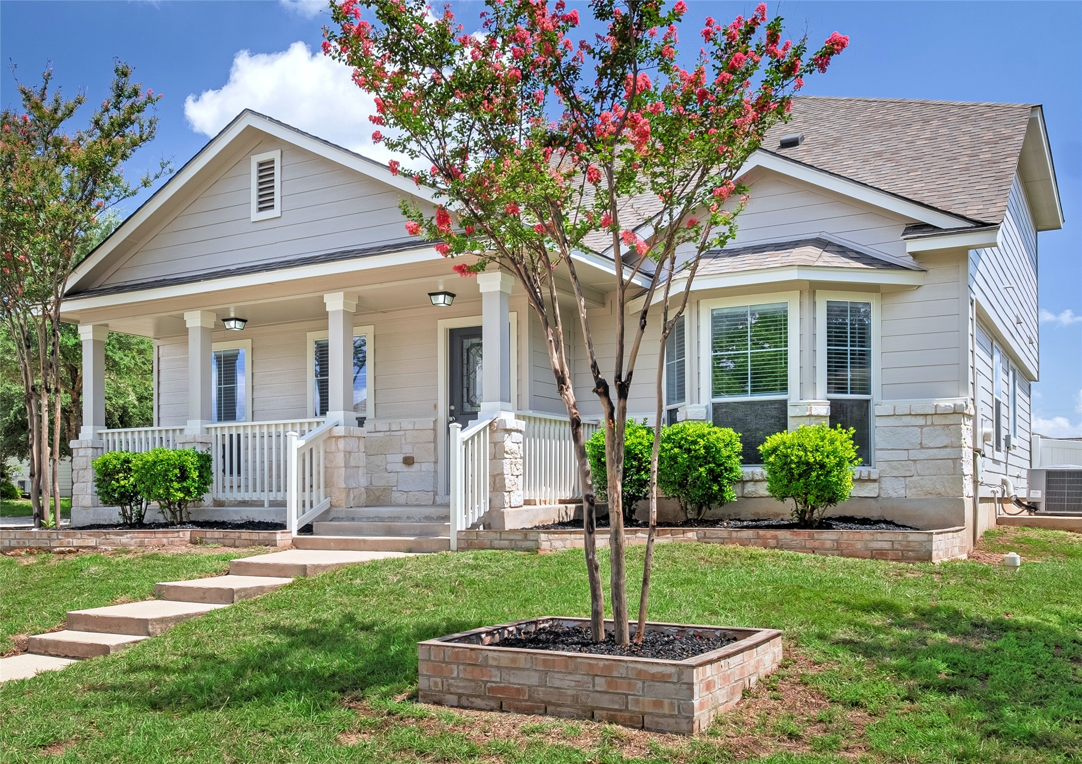 1400 Portchester Castle Path Pflugerville, TX 78660 - Photo 1 of 40 View of front of house featuring a porch, stone siding, and a front yard