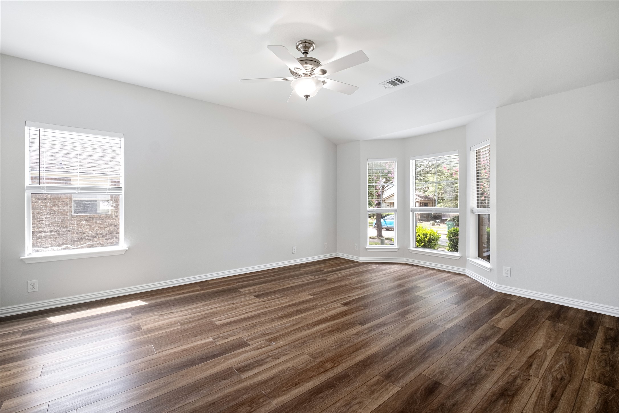 1400 Portchester Castle Path Pflugerville, TX 78660 - Photo 19 of 40 Unfurnished room featuring dark wood-style flooring, a ceiling fan, and vaulted ceiling