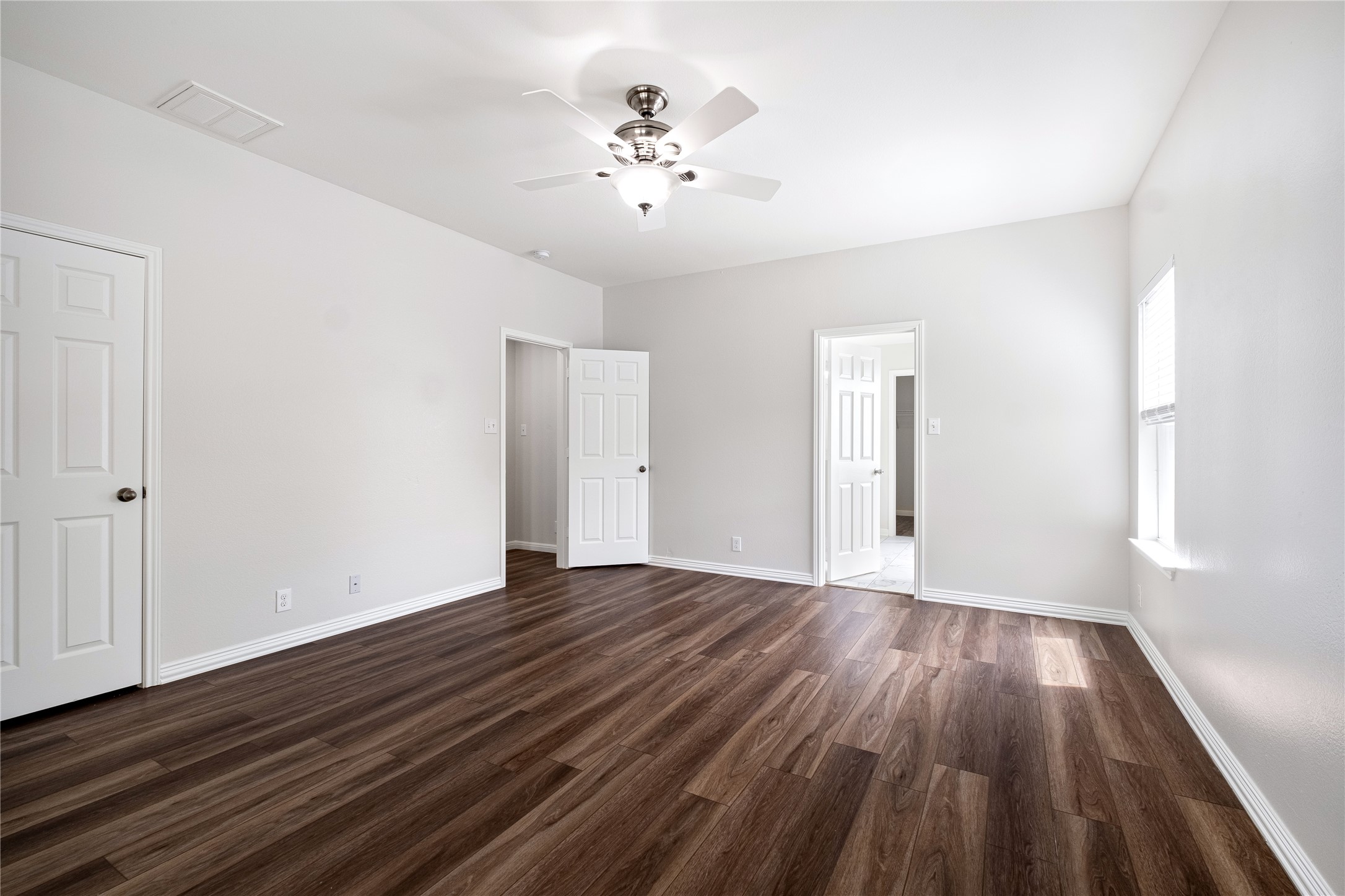 1400 Portchester Castle Path Pflugerville, TX 78660 - Photo 22 of 40 Unfurnished bedroom with a ceiling fan and dark wood-type flooring