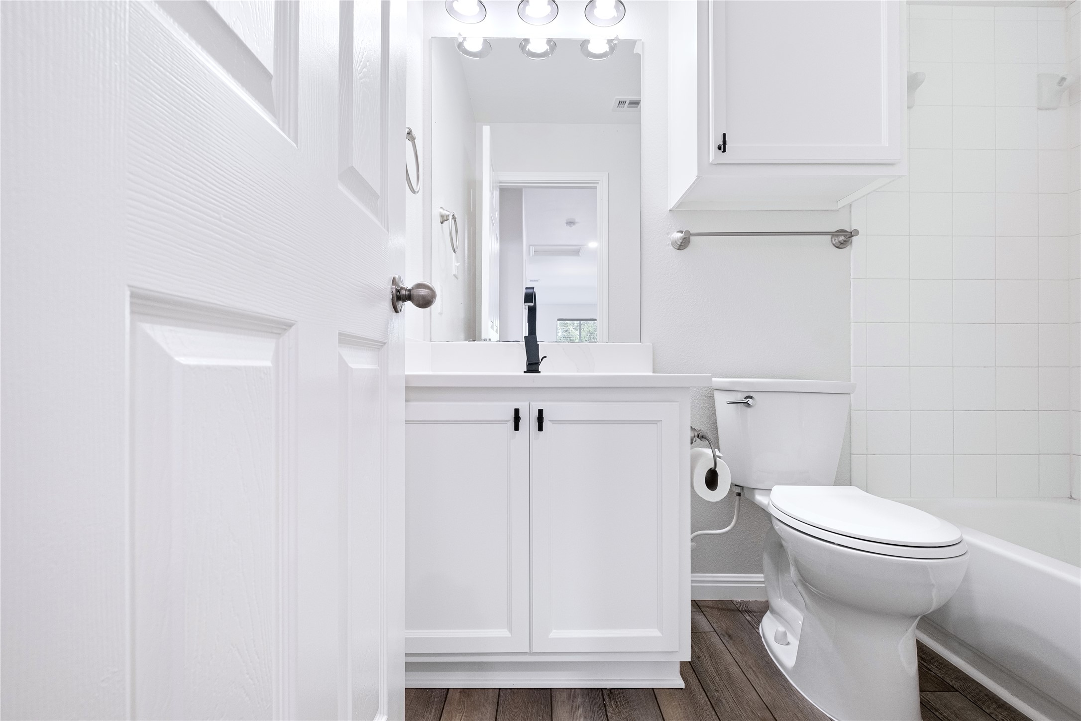 1400 Portchester Castle Path Pflugerville, TX 78660 - Photo 29 of 40 Full bath with vanity, dark wood-type flooring, and bathing tub / shower combination