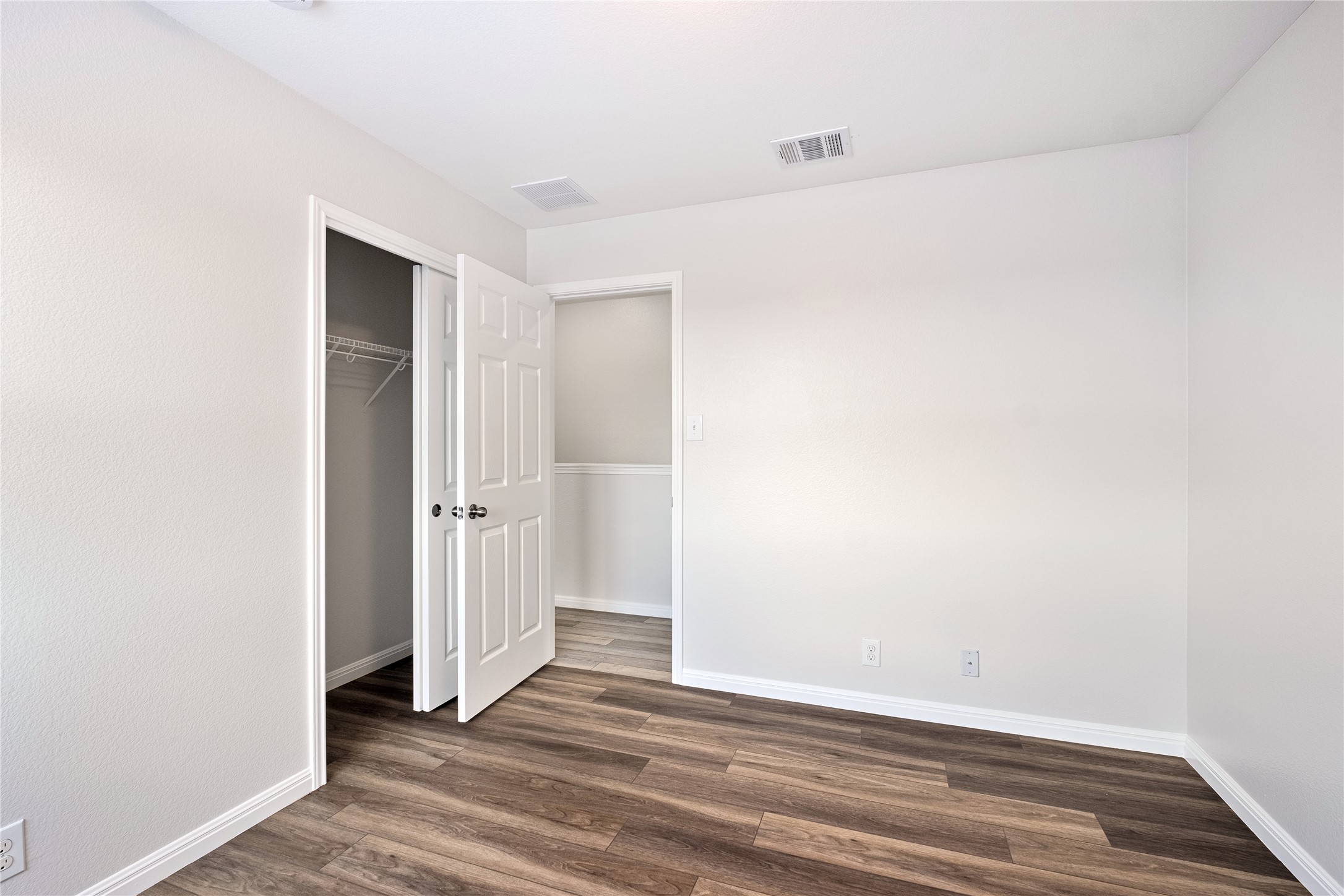 1400 Portchester Castle Path Pflugerville, TX 78660 - Photo 30 of 40 Unfurnished bedroom with dark wood-style floors and a closet