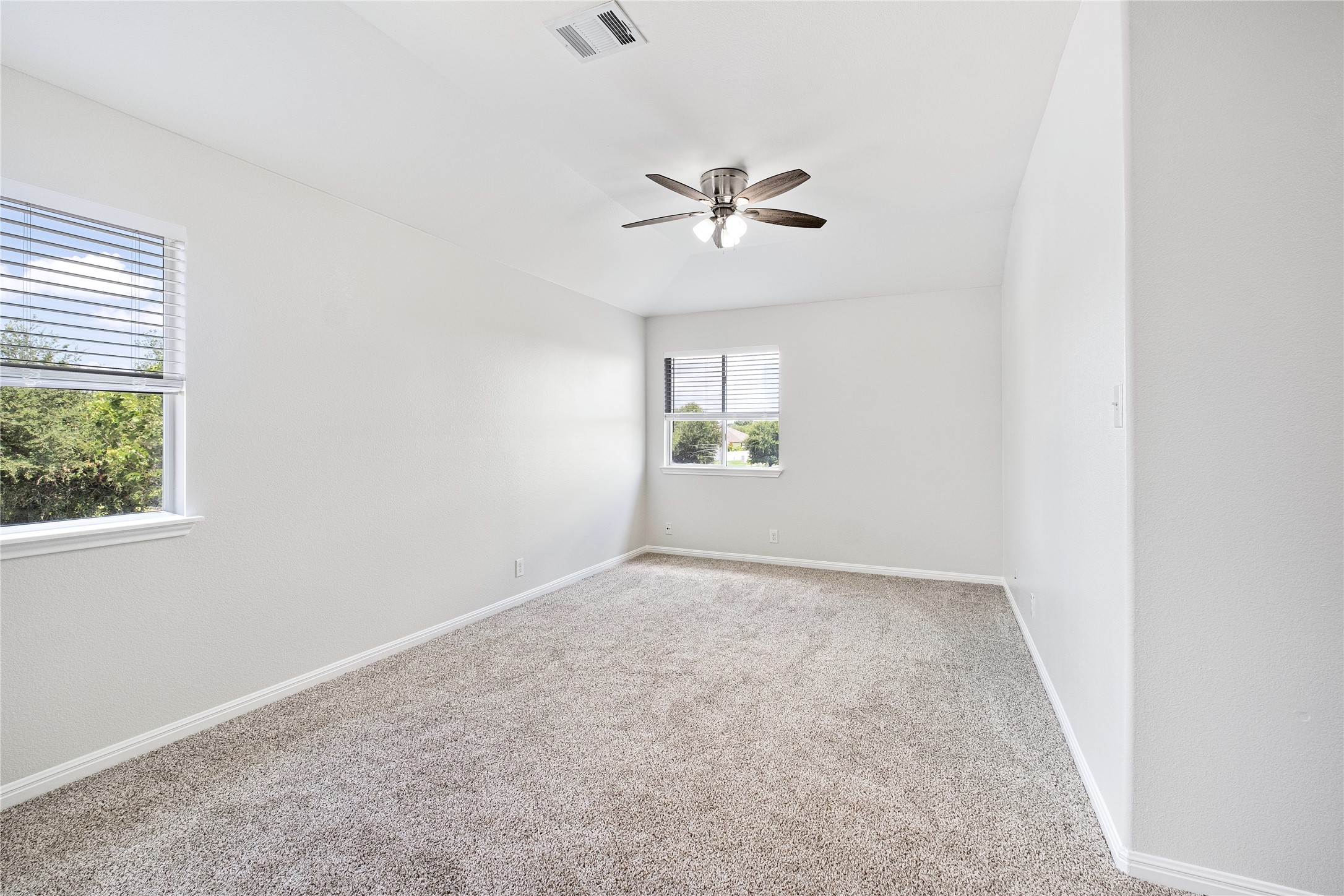 1400 Portchester Castle Path Pflugerville, TX 78660 - Photo 33 of 40 Empty room with light carpet and a ceiling fan