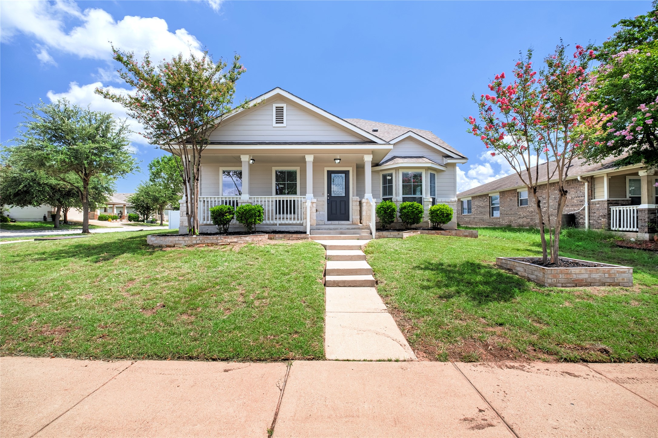 1400 Portchester Castle Path Pflugerville, TX 78660 - Photo 4 of 40 Bungalow-style home featuring a porch and a front lawn