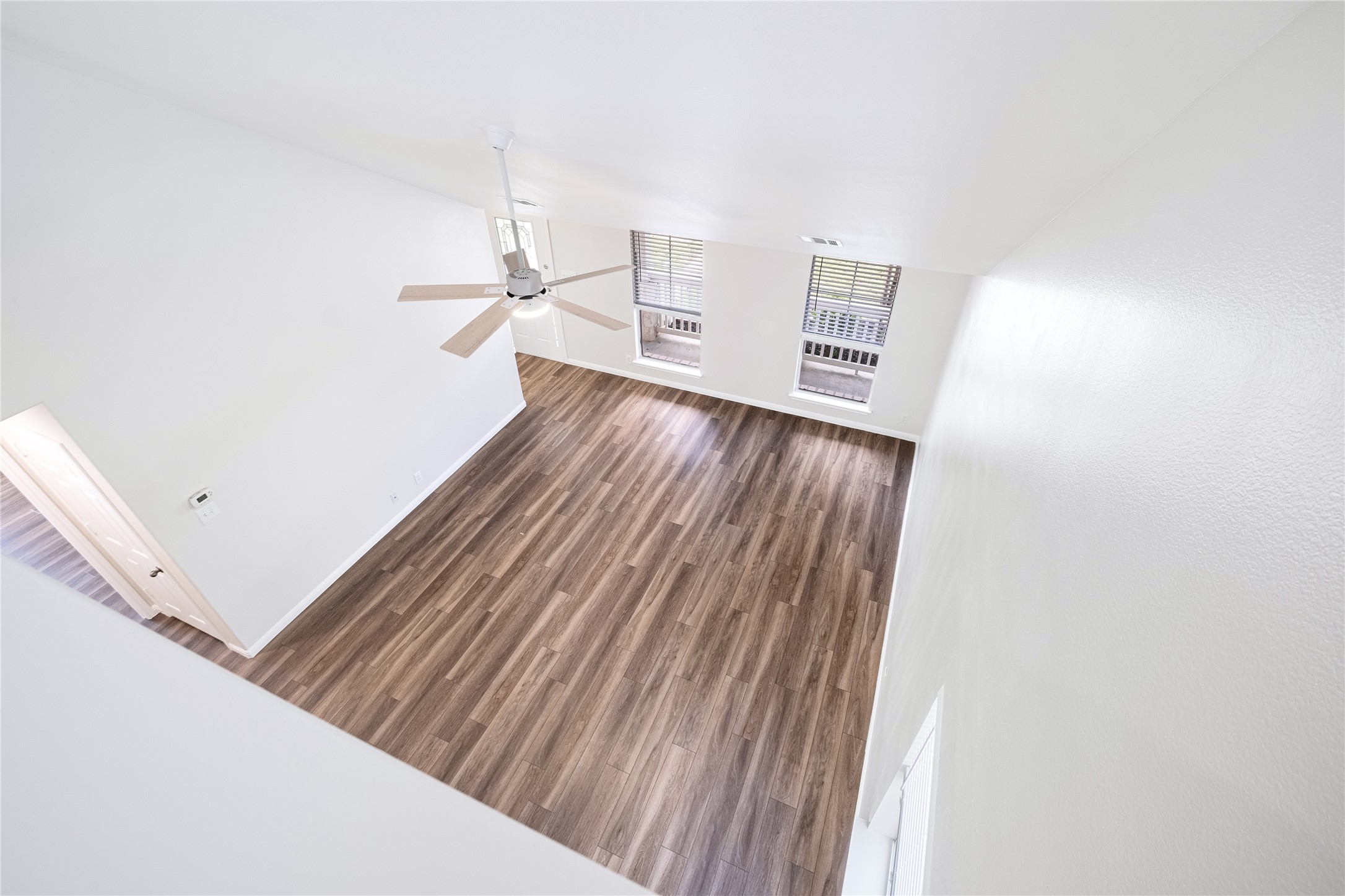 1400 Portchester Castle Path Pflugerville, TX 78660 - Photo 7 of 40 Unfurnished living room featuring dark wood-style floors and ceiling fan