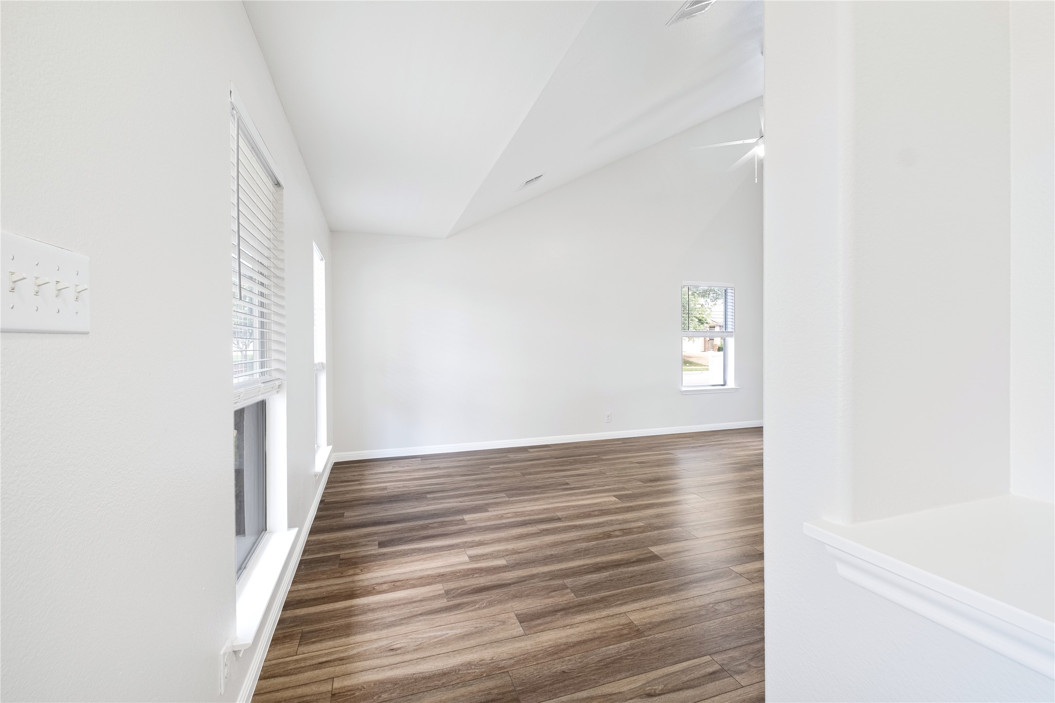 1400 Portchester Castle Path Pflugerville, TX 78660 - Photo 8 of 40 Unfurnished living room with dark wood-style flooring and baseboards