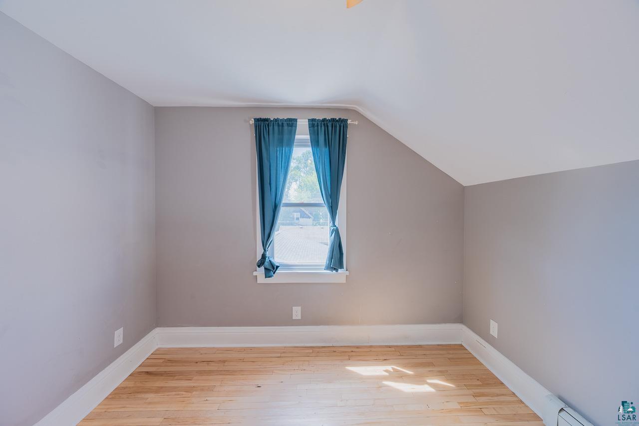 508 10th Street South Virginia, MN 55792 - Photo 23 of 43 Hardwood flooring with a natural finish, light gray wall paint, and white trim