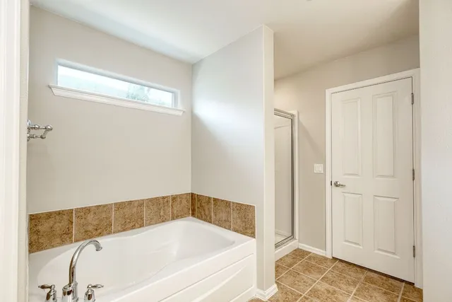a bathroom with a tub and shower