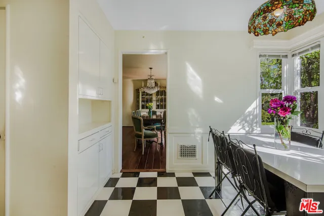 a dining room with furniture and flowers