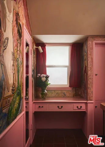 a bathroom with a window and a mirror