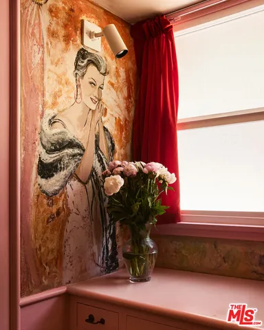 a room with a window and a potted plant